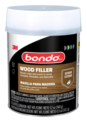 Sanding a filled wood surface to a smooth finish.