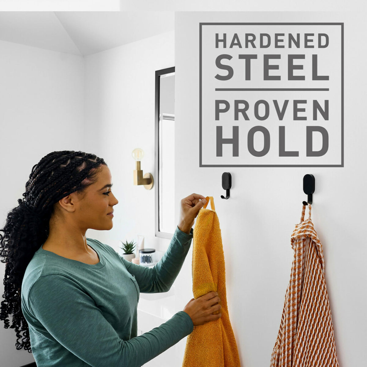 3M CLAW wall hook holding a coat in a tidy entryway