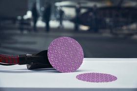 Close-up of dust-extraction holes on 3M Xtract Net Disc 710W for cleaner air.