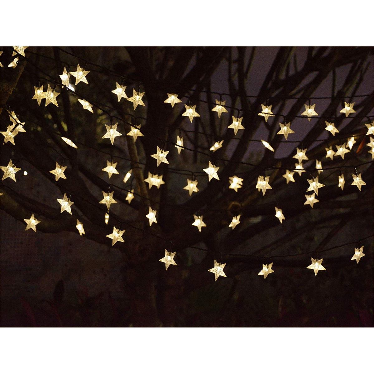 Abkshine camping setup with solar star lights beside a tent.