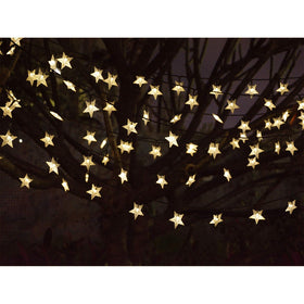 Abkshine camping setup with solar star lights beside a tent.