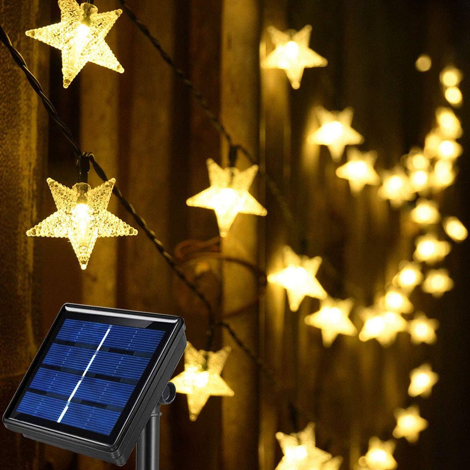 Abkshine solar star string lights illuminate a cozy outdoor area at dusk.