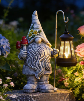 Acgarten garden gnome statue with lantern brightens outdoor scenes with gentle solar glow.
