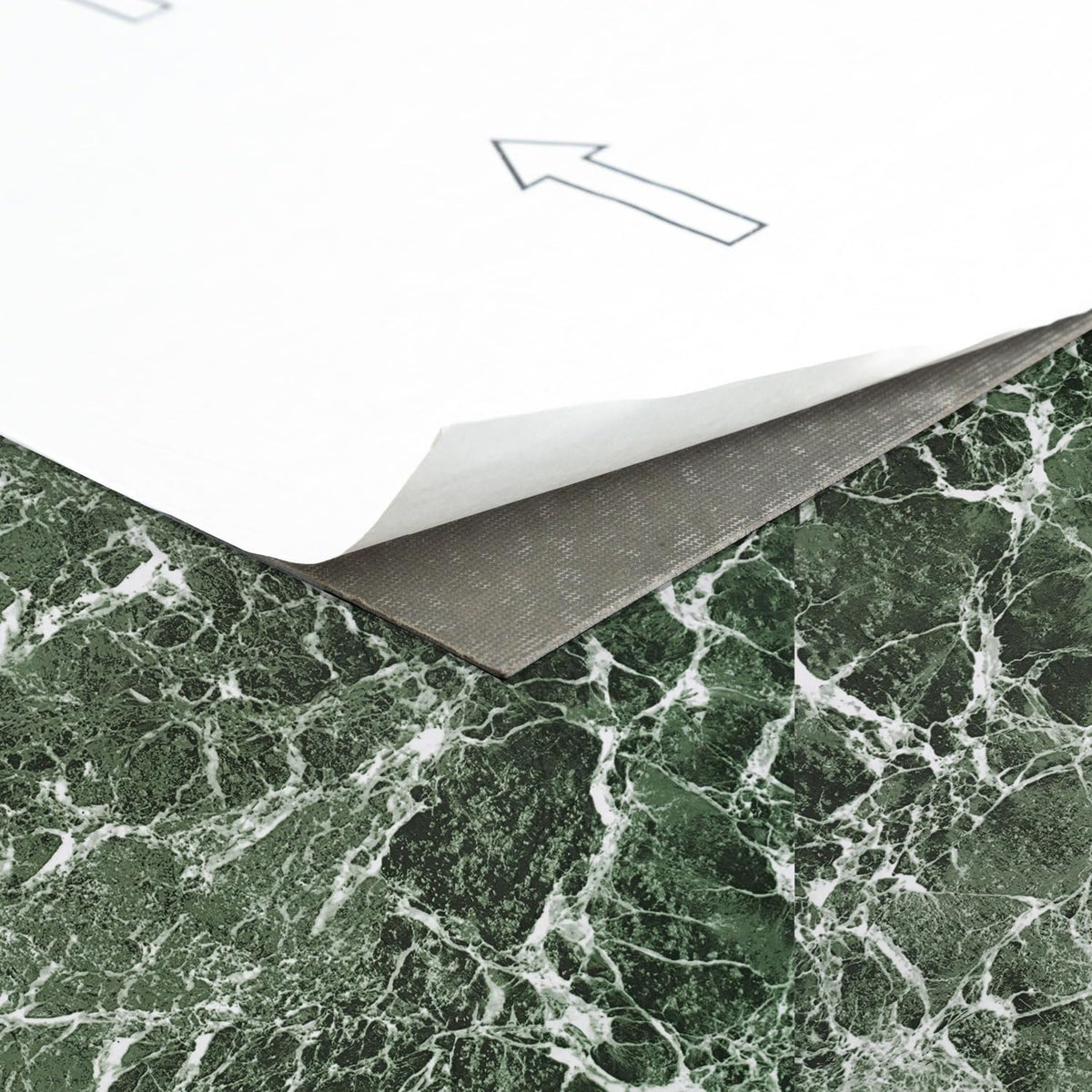 Nexus Forest Marble peel-and-stick tiles during setup on a flat surface
