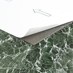 Nexus Forest Marble peel-and-stick tiles during setup on a flat surface