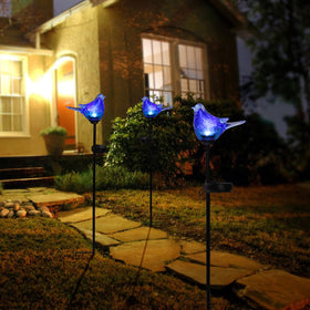 Afirst bluebird stake lit at night provides gentle pathway illumination.