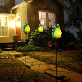 Afirst hand blown glass frog shines without wiring for outdoor spaces.