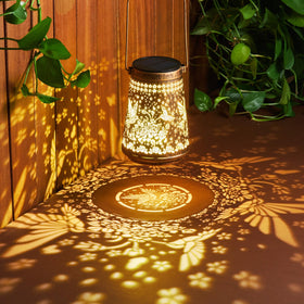 Ahaorigin hollowed metal lantern adds decorative patterns to a porch.