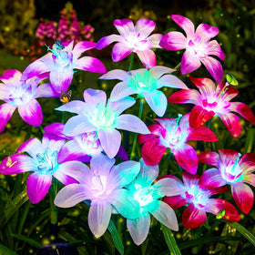 Ahaorigin Lily solar lights illuminate a yard with blooming lilies at dusk