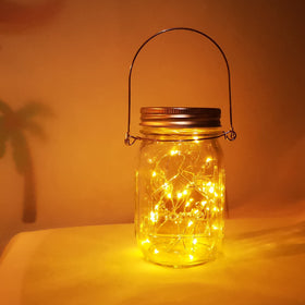 Aikeve mason jar lanterns hung outdoors add rustic charm.
