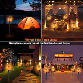 Aityvert night scene shows flickering flames creating warm outdoor ambiance.