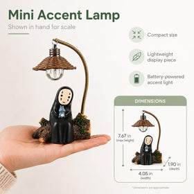 Amallino No Face Lamp hand-painted resin detail enhances collectible decor on a bookshelf.