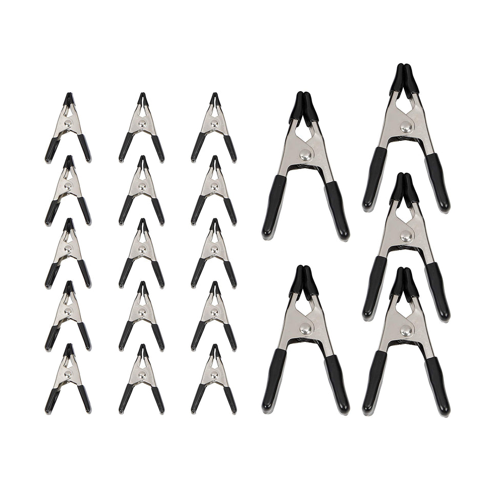 Amazon Basics 20-piece steel spring clamp set on workbench for versatile securing.