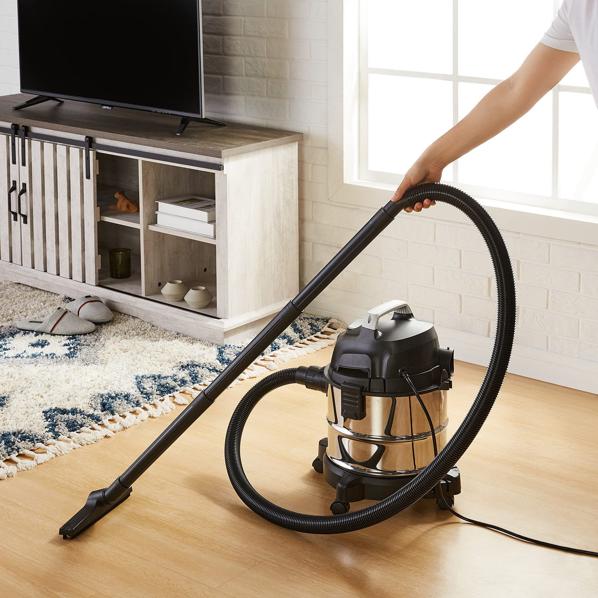 Amazon Basics stainless steel tank vacuum shown, built to endure repeated use on tough messes.