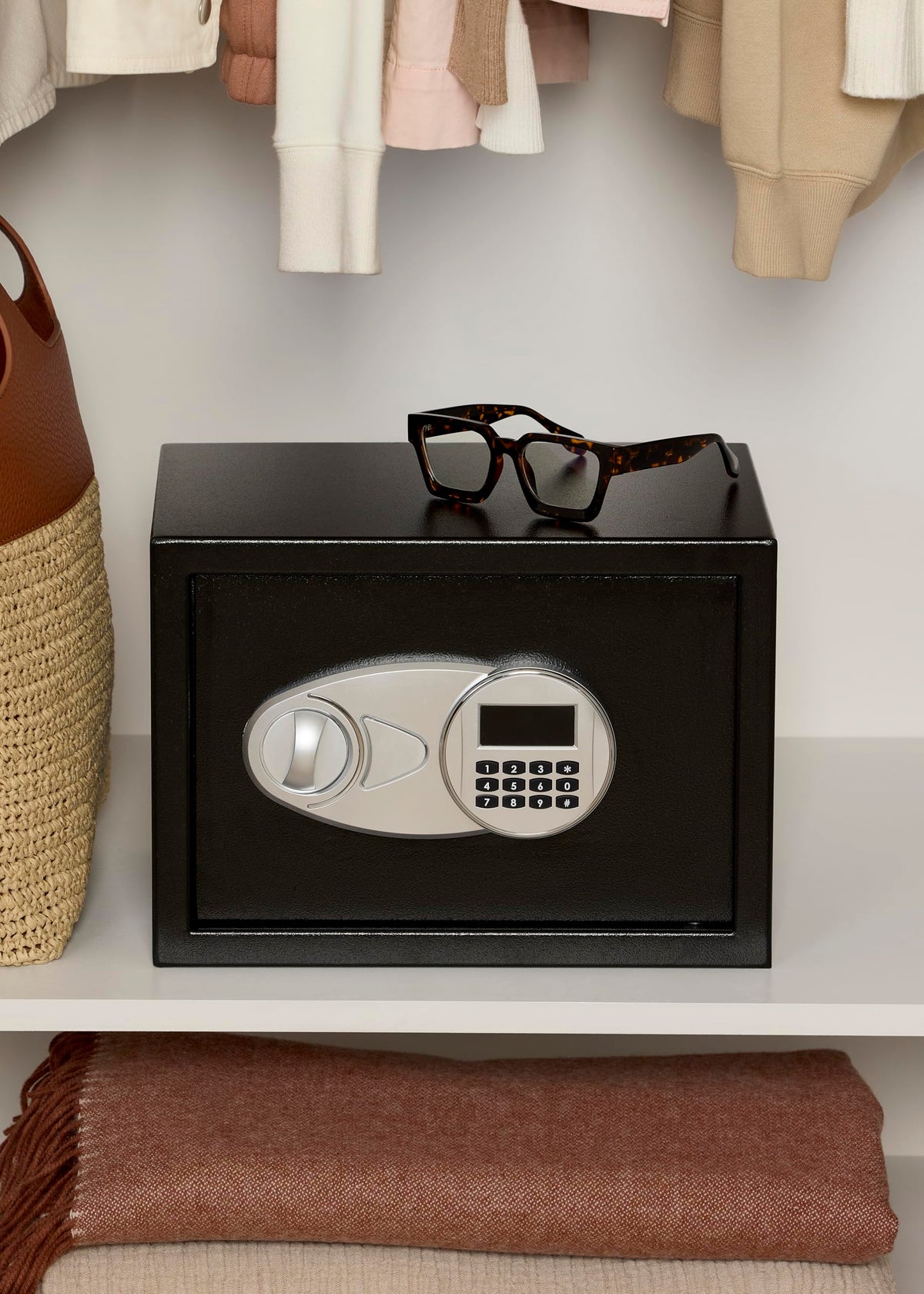 Amazon Basics steel security safe interior with shelf demonstrates organized storage options.