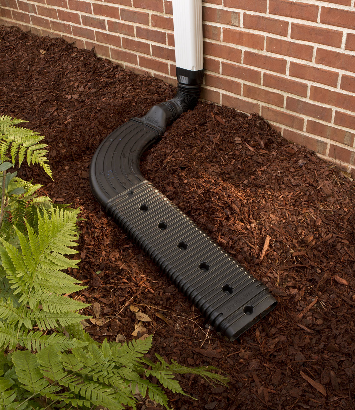 Amerimax StealthFlow 4631 connected to a downspout extension for efficient drainage.