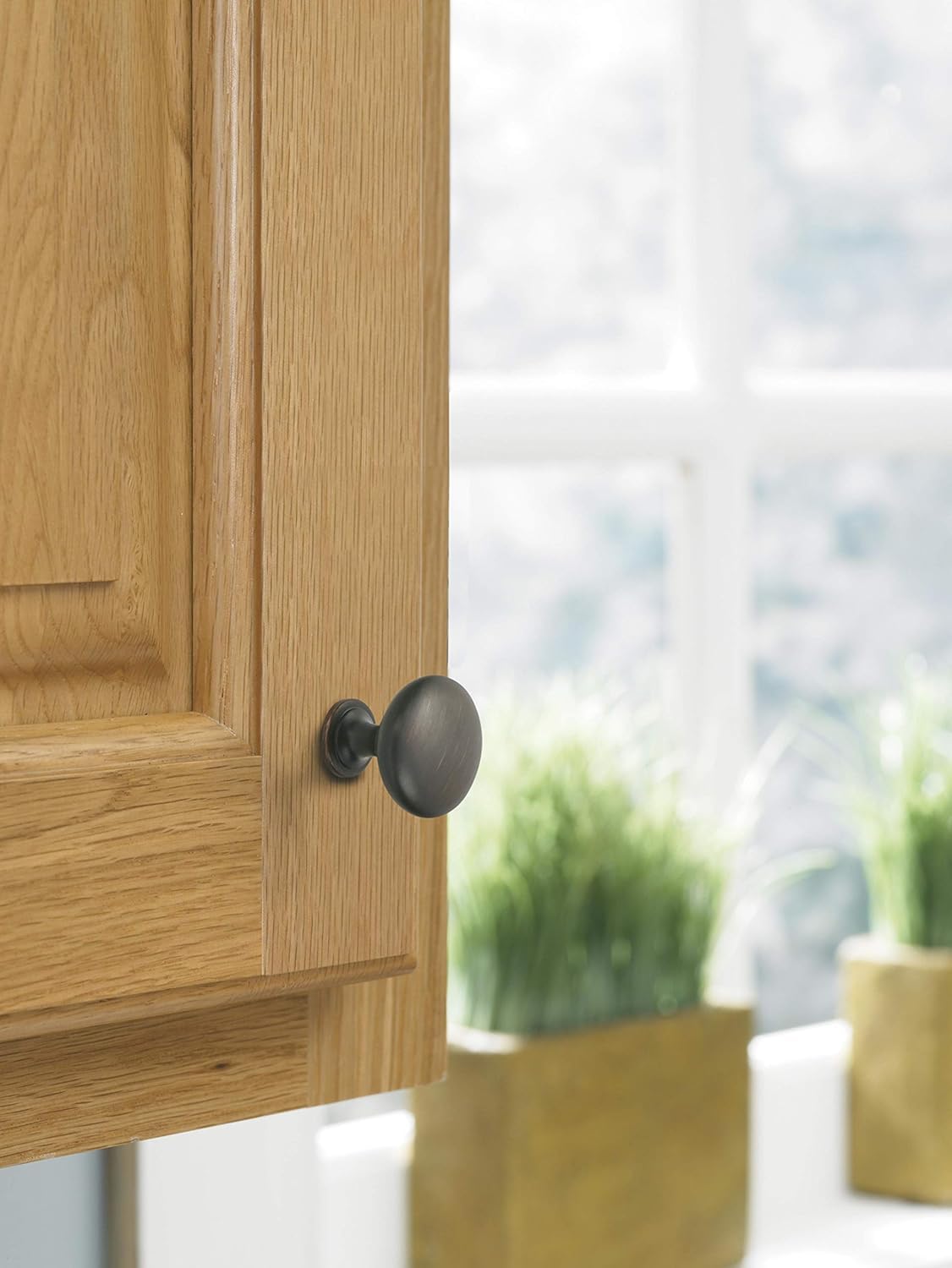Amerock Edona close-up shows textured bronze finish with copper highlights.