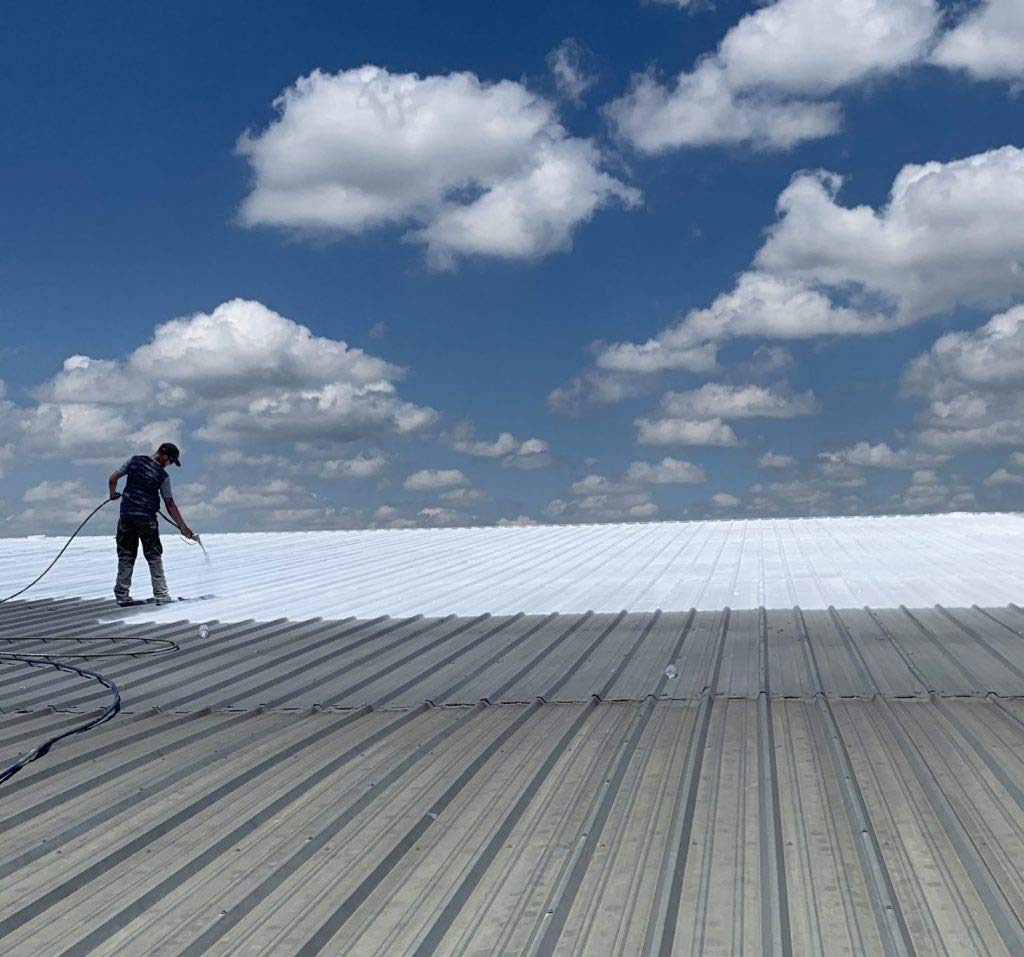 AMES Maximum-Stretch coating being applied with a brush for precise roof sealing.