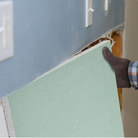 Amylove drywall patch in living room demonstrates quick hole repair