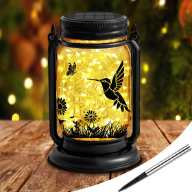 ANGMLN hummingbird lantern on hanger creates graceful outdoor glow.
