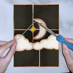 ANOSON workspace with soldering area for stained glass projects.