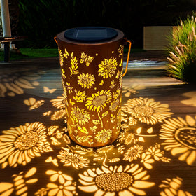 AnyTalk sunflower lantern pattern casts warm light on a wall at dusk.