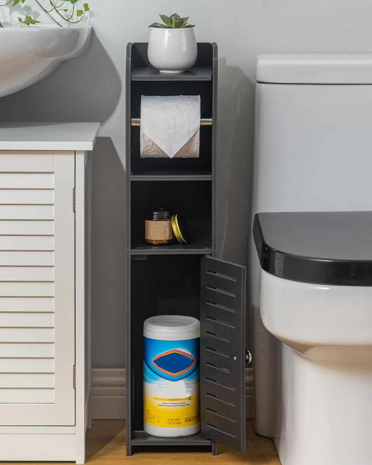 AOJEZOR toilet paper stand top shelf stores glasses and small items.