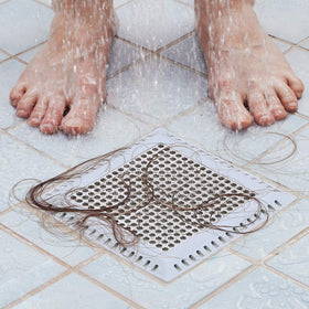 Aojuxix patented shower drain catcher on a bathroom floor drain for enhanced drainage