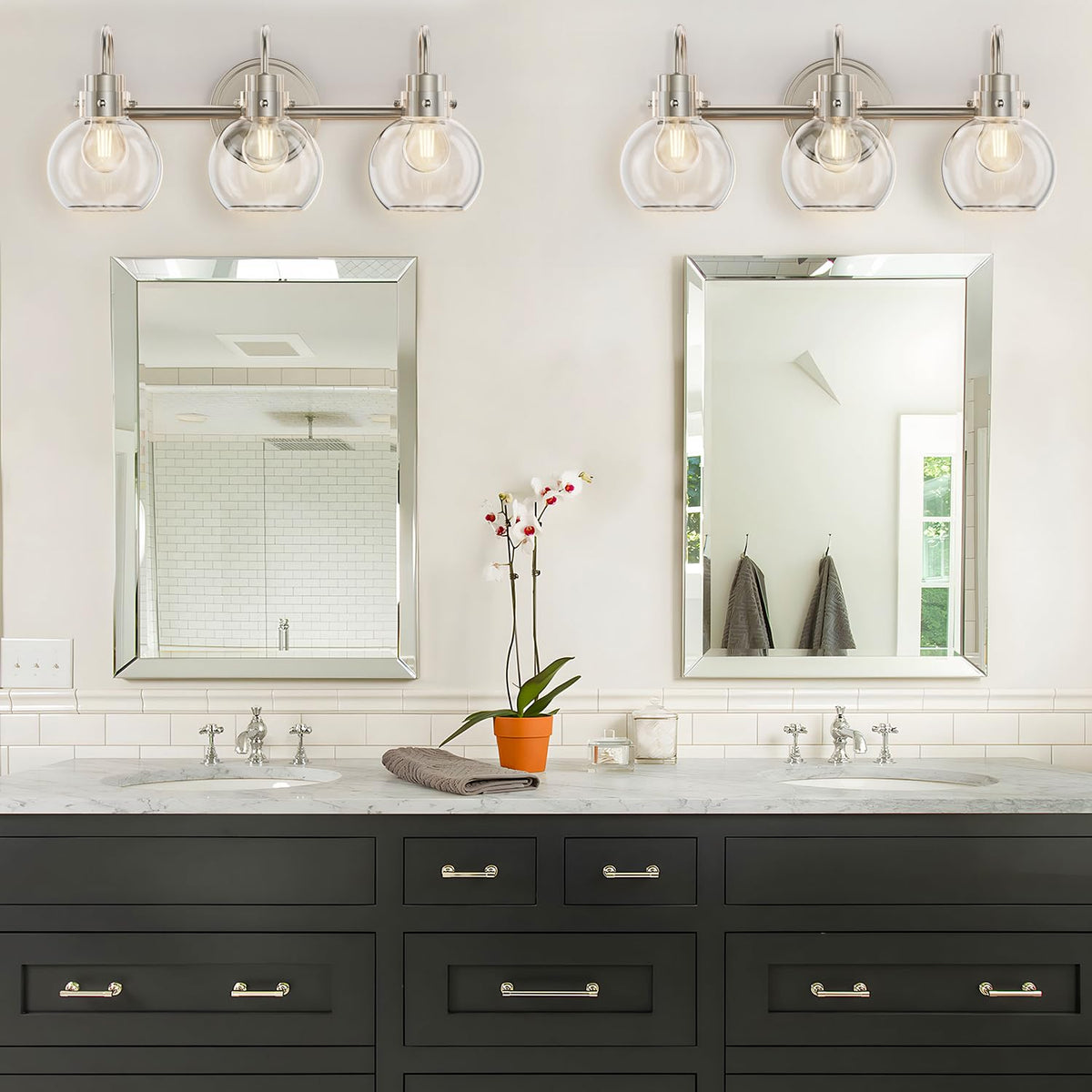 Apenath globe-clear-glass shade wall sconce ideal for bathrooms and entryways.