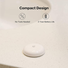 Aqara Water Leak Sensor installed under kitchen sink for monitoring.