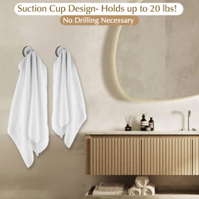 ARBELLE INNOVATIONS suction hooks brushed gold grip loofahs and robes on tile.