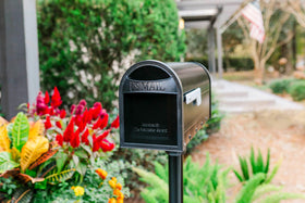 Architectural Mailboxes Carlisle postmount mailbox, USPS approved badge for reliable deliveries.