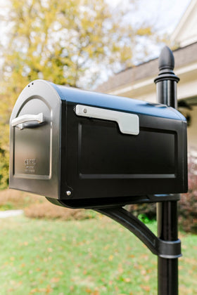 ARCHITECTURAL MAILBOXES Centennial postmount side view highlights sleek black powder coating and rust resistance.