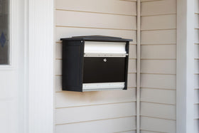 ARCHITECTURAL MAILBOXES Mailsafe black finish blends with modern exteriors.