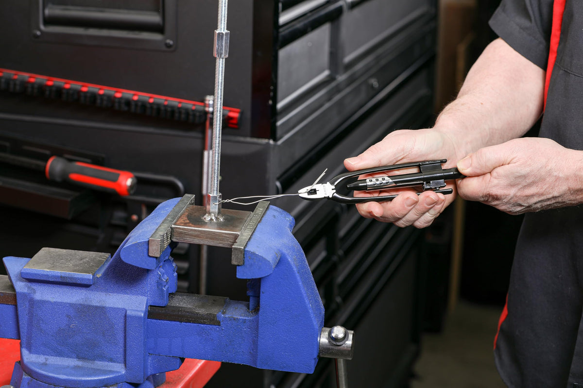 ARES pliers cutting stainless safety wire with built-in cutters.