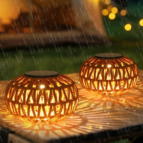 Artmooy two-pack solar lanterns on a table casting a warm inviting glow
