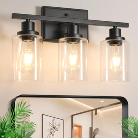 Ascher 3-light vanity fixture in matte black illuminates the bathroom with a refined modern look.