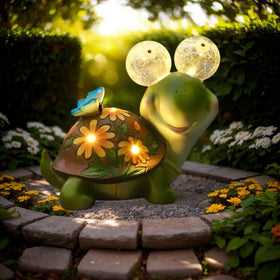 ASTRAEUS solar turtle statue front view glows softly, enhancing outdoor ambiance.
