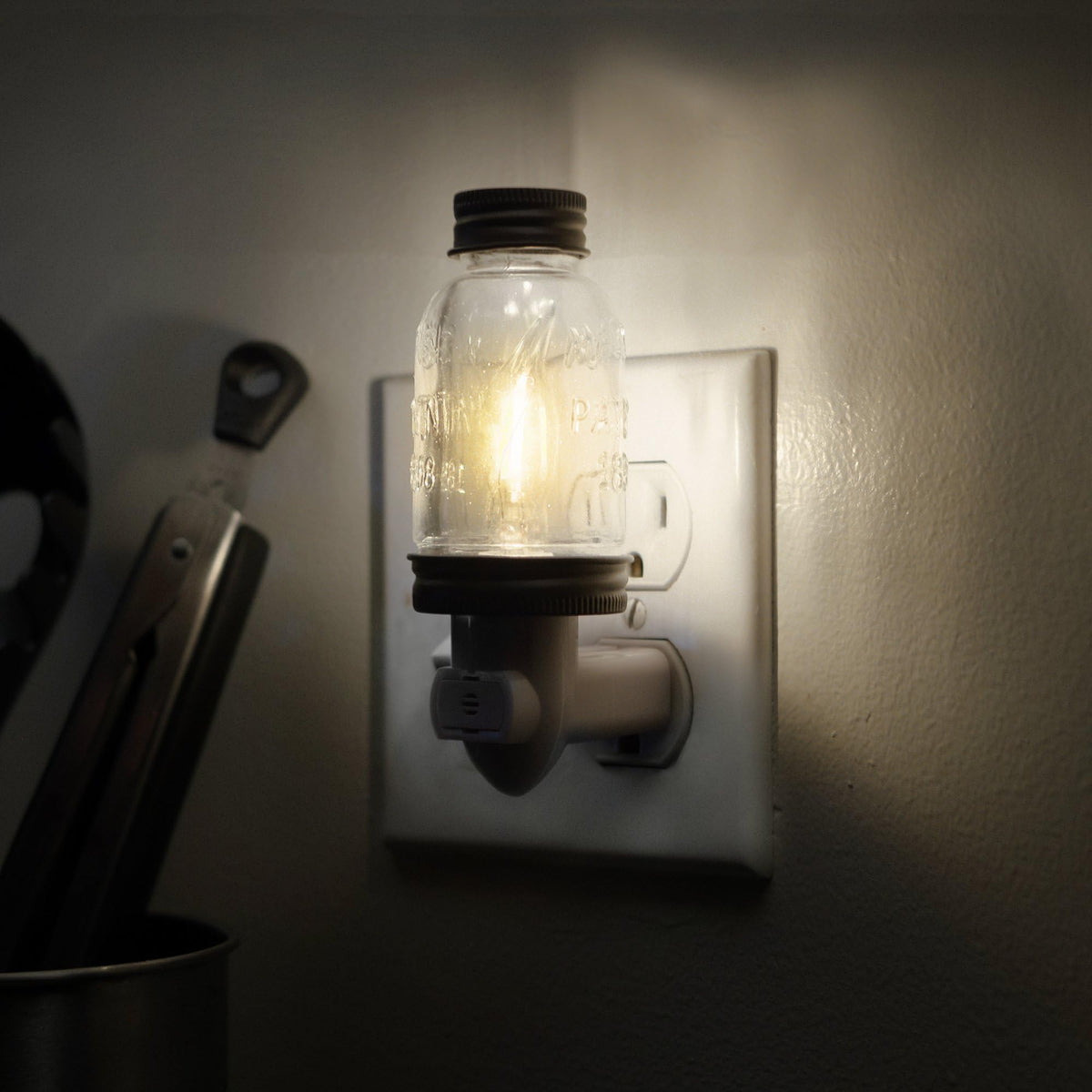 close-up of plug-in base on autumn alley night light for easy installation.