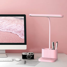 AXX pink desk lamp in dorm room setup adds cheerful ambiance and study-friendly lighting.