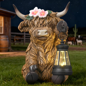 Ayadon Solar Highland Cow statue glows softly at dusk, enhancing garden ambiance.