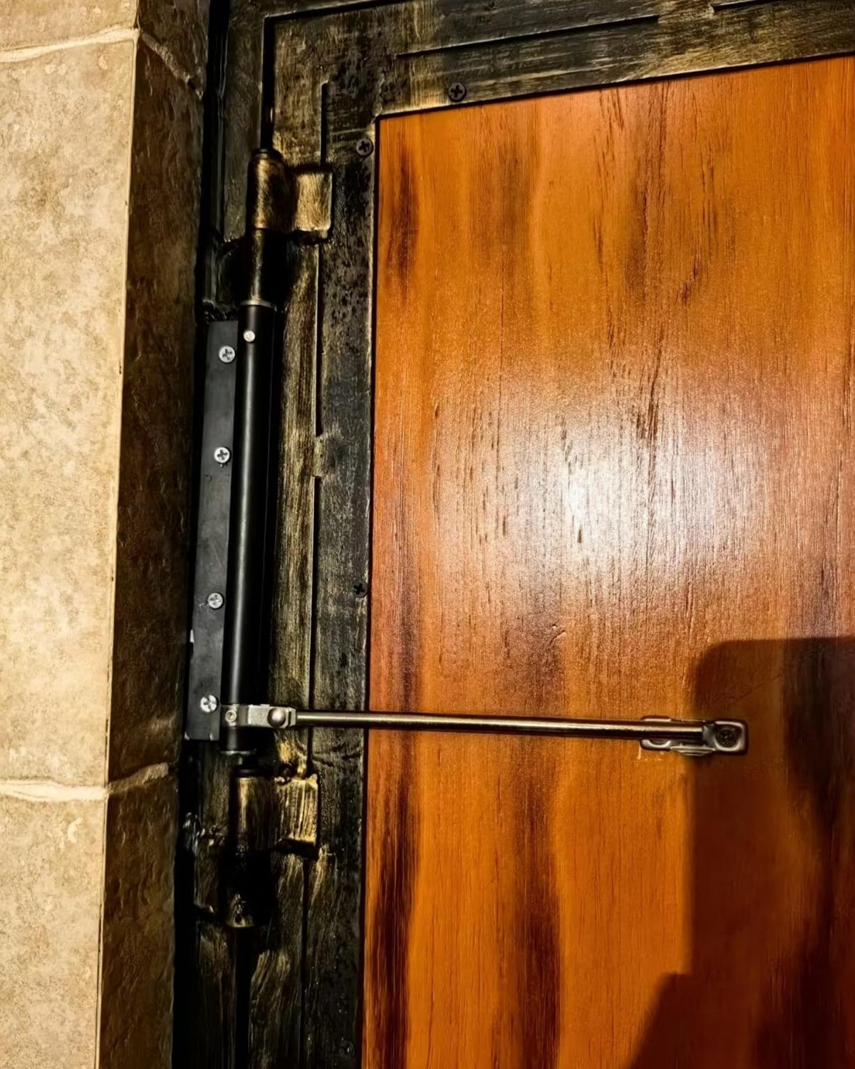 Bellairis door closer installed on wooden door with screwdriver-ready setup.