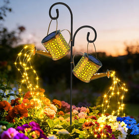 BETOLEAN solar watering can light outdoor with flowing star glow along the garden path.