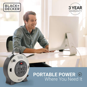 In-use view of Black+Decker 25ft retractable extension cord reel in a small space.