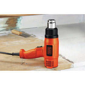 BLACK+DECKER HG1300 heat gun in action for paint stripping and rust removal.