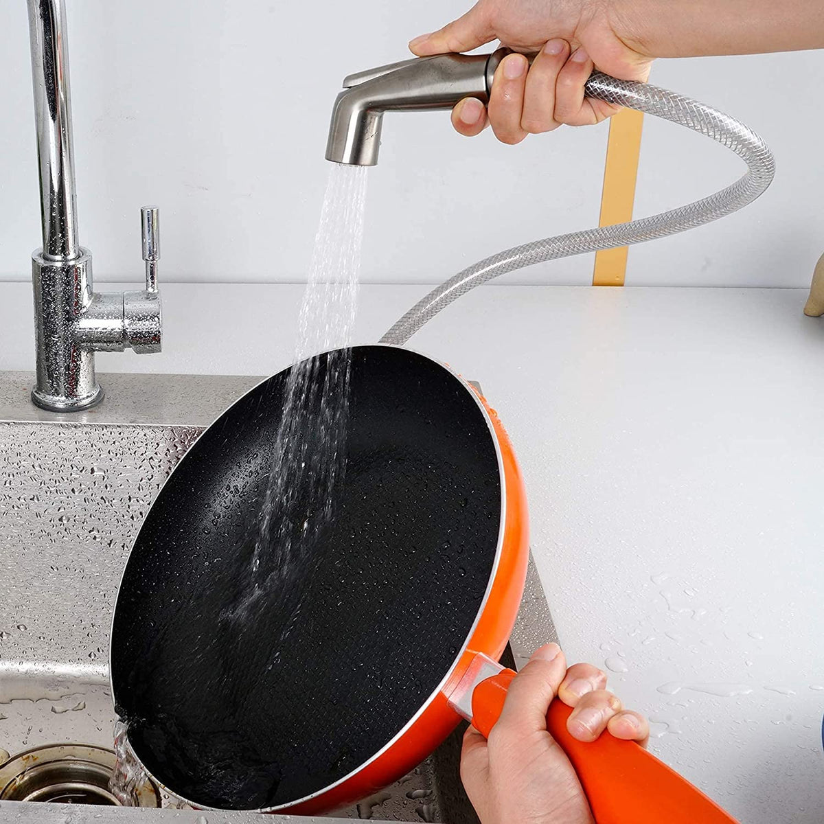 One-thumb control Blissvent sprayer in action on a kitchen sink