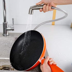 One-thumb control Blissvent sprayer in action on a kitchen sink