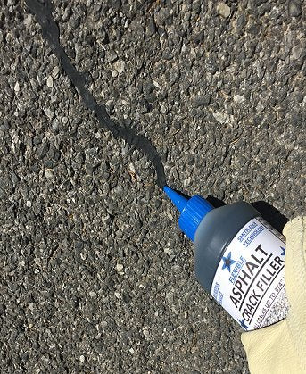 Blue Star asphalt crack filler during driveway application demonstrates sealing cracks to prevent damage