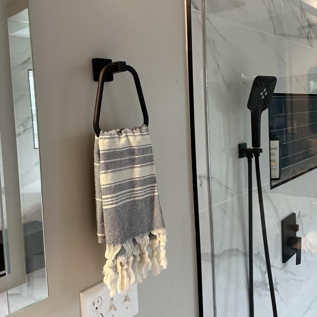 BlueByrne matte black towel ring on wall mount complements modern bathrooms.