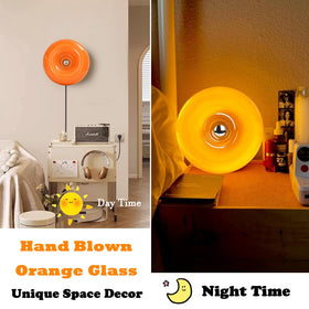 Bofea wall sconce emits a soft orange glow ideal for bedrooms.